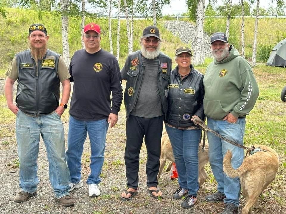 Combat veterans in motorcycle gear at an outdoor gathering